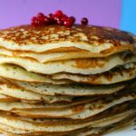 Pancake dorati con un ingrediente segreto, serviti su un piatto decorato.
