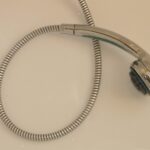 Silicone del box doccia ingiallito da sostituire, con strumenti per la rimozione e applicazione.